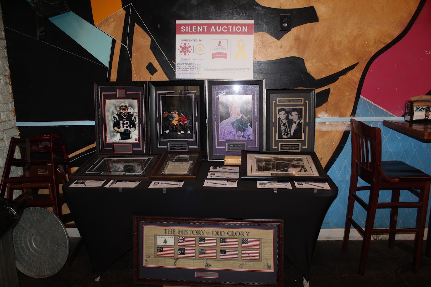 Community memorabilia and silent auction display inside Benny Pennello's in Charlotte