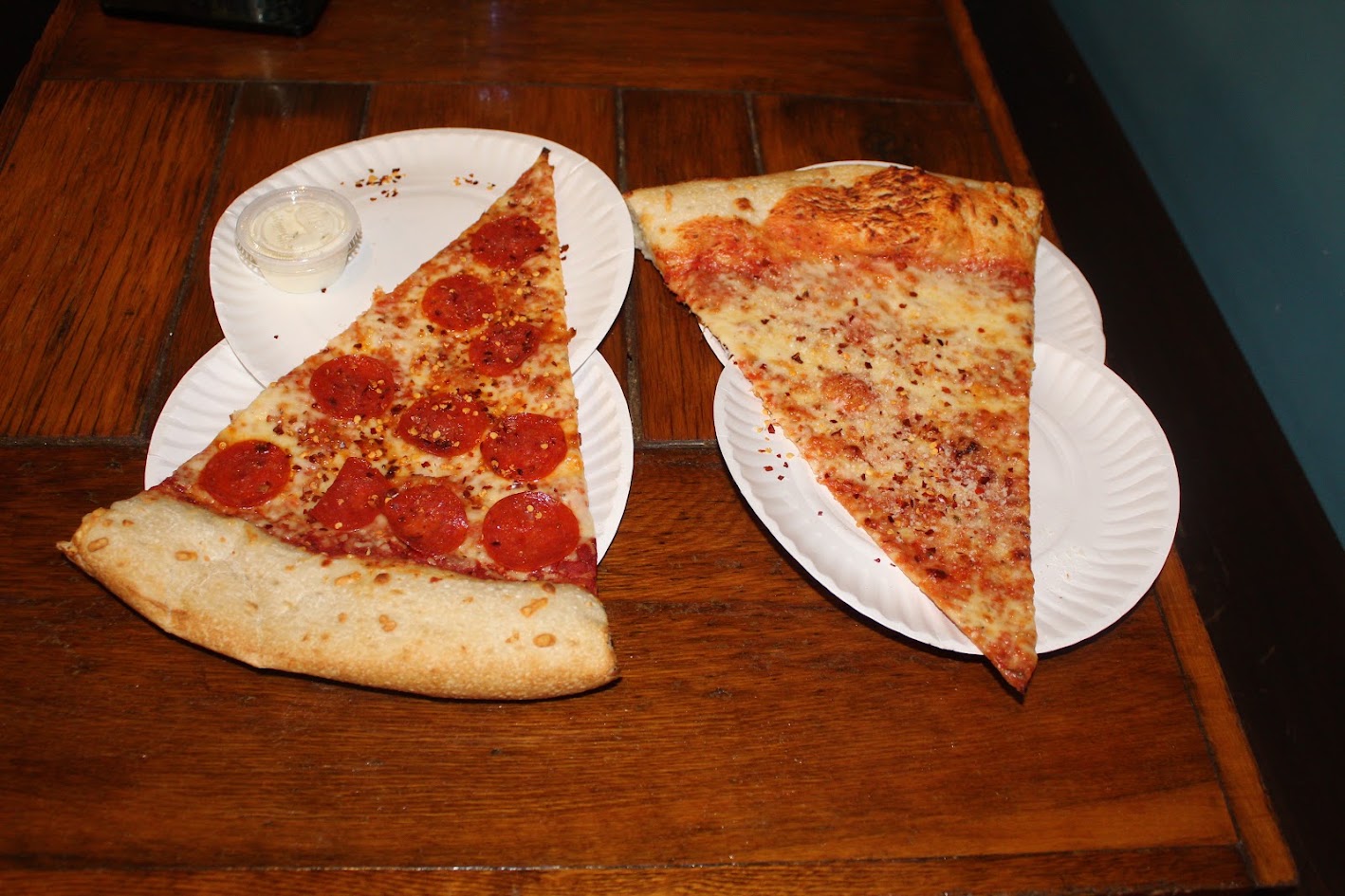 Oversized pepperoni and cheese pizza slices from Benny Pennello's in Charlotte