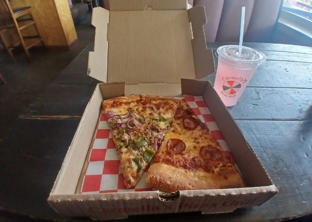 Two slices of pizza from Carmella’s Pizza Grill on South Tryon Street in Charlotte