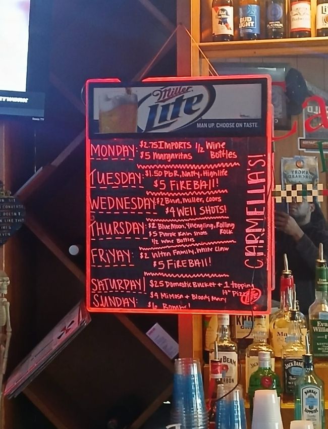 Daily drink specials displayed at Carmella’s Pizza Grill South Tryon