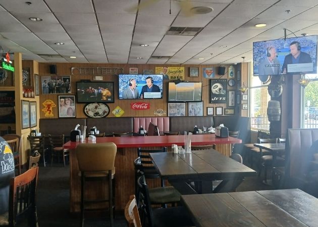 Open seating area inside Carmella’s Pizza Grill South Tryon