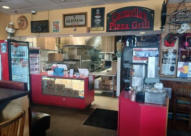 Order counter inside Carmella’s Pizza Grill on South Tryon Street