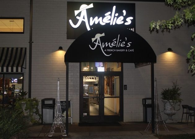 Amélie's French Bakery and Cafe illuminated storefront in NoDa Charlotte at night