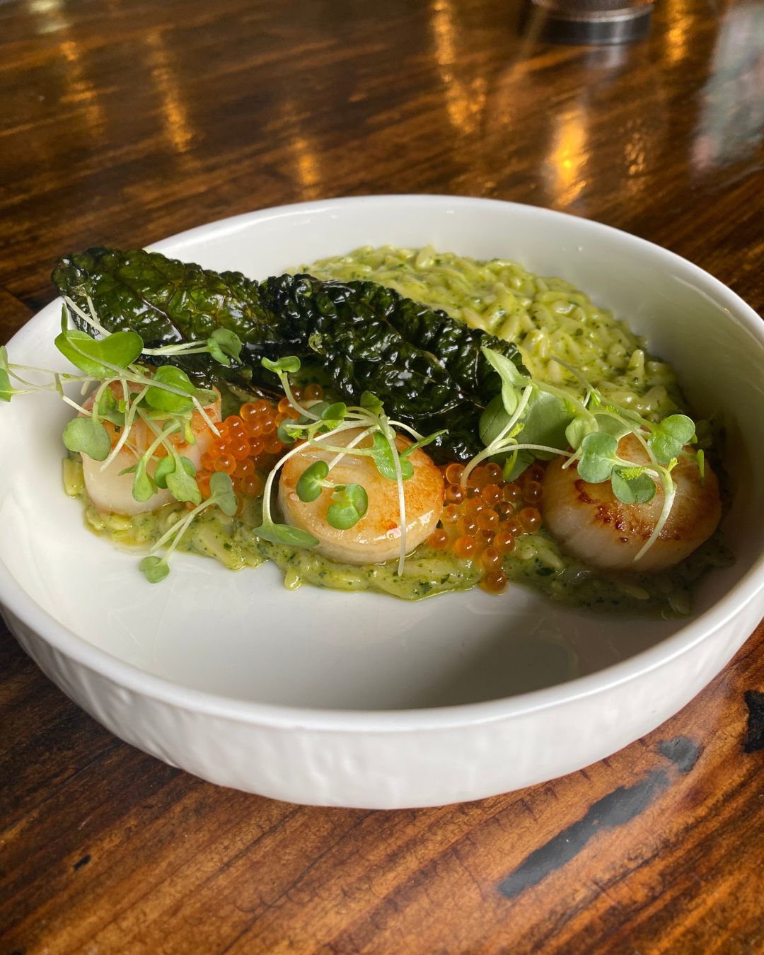 Seared scallops with lacinato kale orzo at The Artisan's Palate