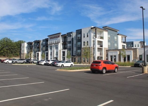 Bask Apartments exterior building and now leasing view in Steele Creek Charlotte