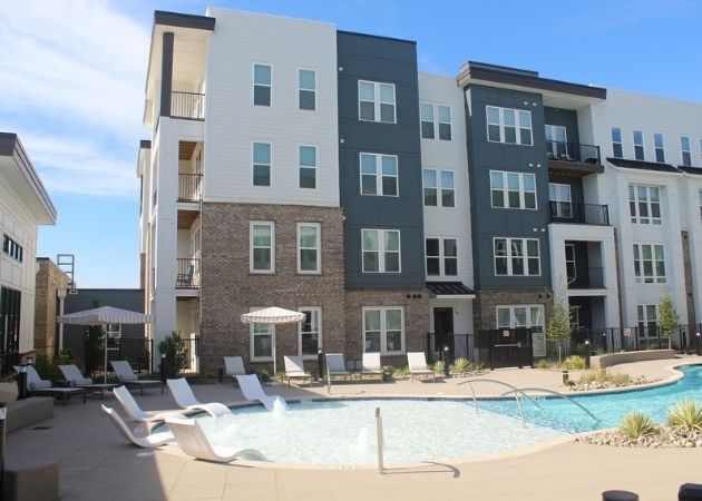 Outdoor pool seating at Bask Apartments in Steele Creek Charlotte