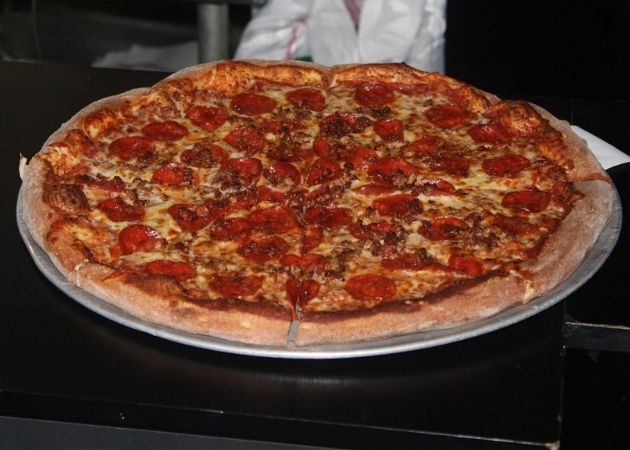 Whole pizza and spinach footballs at Carmella's Montford