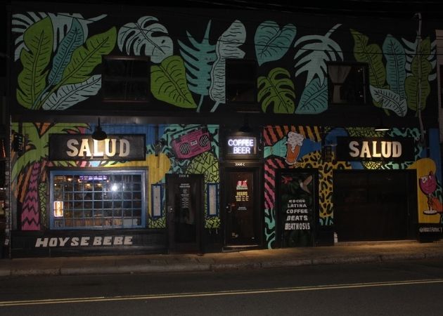 Salud beer shop and bar storefront at night in NoDa Charlotte