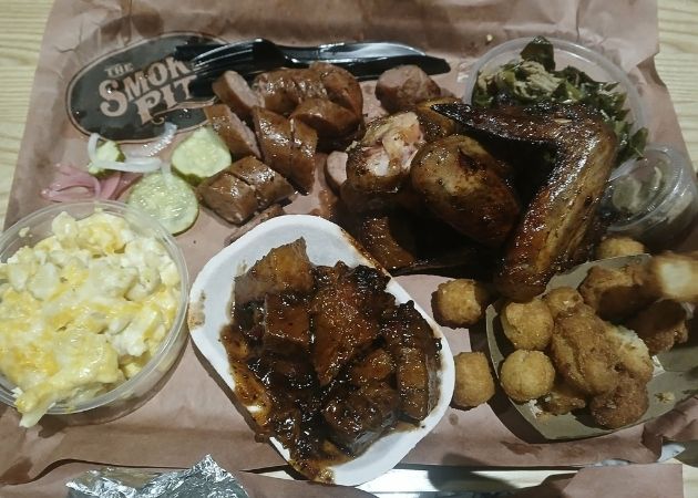 Smoked sausage and wings with sides at The Smoke Pit Charlotte