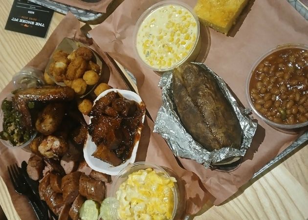 Smoked sausage, chicken wings, and sides at The Smoke Pit Charlotte